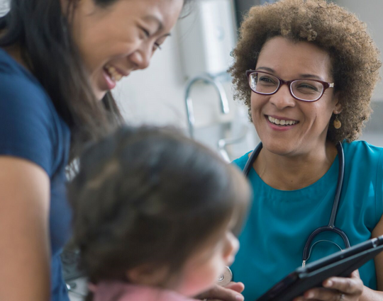 Doctor using digital tablet with patients