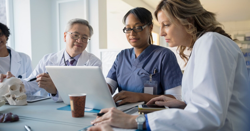 Healthcare professionals looking at a laptop