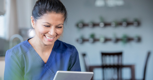 Healthcare professional using a tablet to communicate with a patient