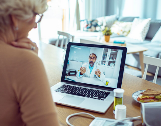 Close up of a senior woman consulting with her doctor online on her laptop